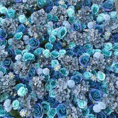 blue and green flowers are in the middle of a garden planter, as seen from above