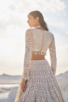 This nude net lehenga set features ivory thread, sequin, and pearl embroidery. The plunging neckline shows pearls along the v neck. The sleeves of the blouse have pearl tassels at the hem. The dupatta has a scalloped border on all four sides.From Seema Gujral's Elements collection. DELIVERY TIMEPlease allow 6-8 weeks for your outfit to arrive. FABRIC DETAILSNet Professional cleaning only. Pearl Tassels, Seema Gujral, Pearl Embroidery, Scalloped Border, Net Lehenga, Bridal Blouse Designs, Indian Wedding Outfits, Lehenga Designs, Professional Cleaning