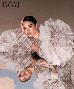 two women in dresses with feathers on them