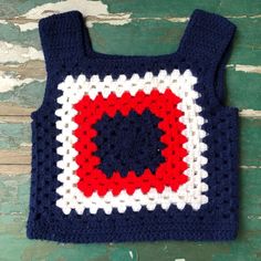 a crocheted bag with a red, white and blue square in the center