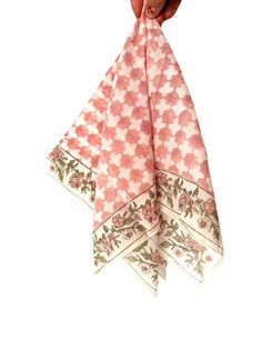 a pink and white flowered handkerchief hanging from a hook