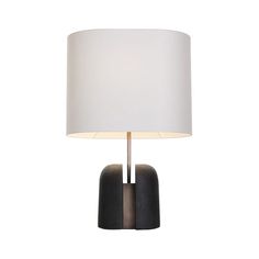 a table lamp with a white shade on it's base and a black stone base