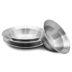 three stainless steel bowls sitting side by side on a white surface with one empty bowl in the middle