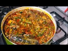 a pot filled with lots of food on top of a stove