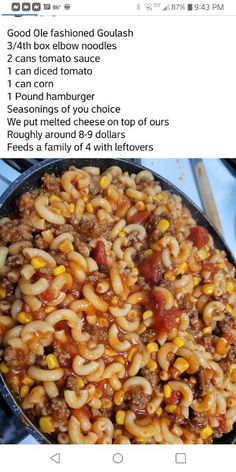 a skillet filled with pasta and meat on top of a stove next to a spatula