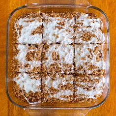 a casserole dish filled with different types of desserts on top of a wooden table