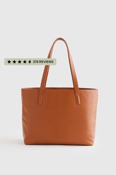 This well designed, full-size, beautiful Italian leather tote bag is perfect for your everyday needs. Includes all the inner organization to keep you on track throughout the day including a 13" laptop slip, iPhone pocket, zipper pocket, plus several other pockets and a hook for your keys. Your go-to everyday tote, no doubt.  | Quince | Women's Classic Italian Leather Tote Bag in Cognac Versatile Shoulder Tote Bag With Interior Card Slots, Large Shoulder Bag With Removable Pouch For Daily Use, Tote Bag With Interior Card Slots For Daily Use, Daily Use Tote Bag With Interior Card Slots, Modern Large Capacity Bags, Modern Large Capacity Bag, Large Everyday Bag With Large Capacity, Shopping Shoulder Bag With Double Handles And Card Slots, Trendy Bags With Interior Card Slots For Everyday Use