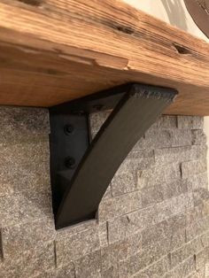 a close up of a wooden shelf on a brick wall