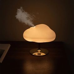 a cloud shaped lamp sitting on top of a table