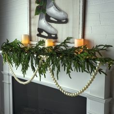 a fireplace mantel decorated with candles and ice skates