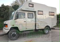 an off - road camper is parked in the parking lot