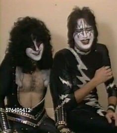 two people dressed in black and white makeup