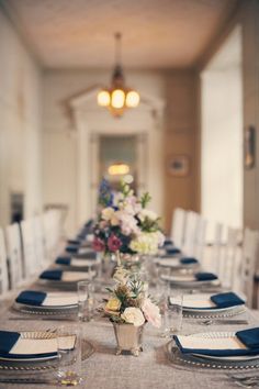 the table is set with blue and white place settings