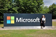 a woman standing in front of a microsoft sign