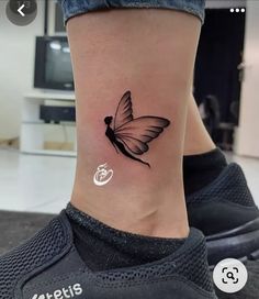 a small butterfly tattoo on the ankle