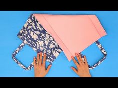 someone is making an origami kite out of fabric and paper with their hands