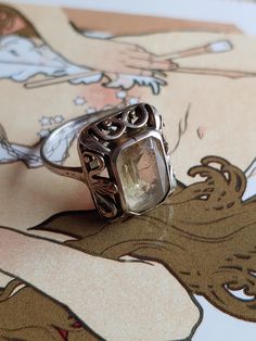 "A beautiful, German Jugendstil style silver Art Nouveau Citrine 835 silver ring. Circa 1920s. This item is vintage/antique, there is wear due to age. **This item is 8.75\" US** Jugendstil: (\"Youth Style\") was an artistic movement, particularly in the decorative arts, that was influential primarily in Germany and elsewhere in Europe to a lesser extent from about 1895 until about 1910. It was the German counterpart of Art Nouveau. The members of the movement were reacting against the historicism and neo-classicism of the official art and architecture academies. It took its name from the art journal Jugend, founded by the German artist Georg Hirth. It was especially active in the graphic arts and interior decoration. Basic info: Size- Approx. 8.75\" Color: Silver Type- Silver work weight- Silver Art Nouveau Ring As Gift, Silver Art Nouveau Ring For Gift, Neo Classicism, Art Nouveau Sterling Silver Gift Rings, Art Nouveau Nickel-free Jewelry Gift, Art Nouveau Silver Gemstone Jewelry, German Silver, Silver Work, Silver Art