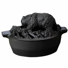 a statue of a bear in a pot