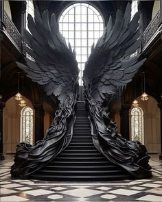 an elaborate staircase with large black angel wings