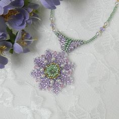 DIGITAL DOWNLOAD ONLY - does NOT include actual pendant or materials. I made this flower with all Mothers in mind!  Mother's Day or Birthday, ANY DAY is a good day for flowers!!   I used mostly 11/0 seed beads along with crystals and pearls. The tutorial includes instructions for the PENDANT ONLY - the necklace's are just suggested.  You are free to slide these flowers on the necklace of your choice whether it be a gold chain or ribbon! Use your inspiration & creativity to combine the colors you like best! SKILL LEVEL - Intermediate or brave beginners Basic beading knowledge required. This tutorial includes - List of materials List of tools Step-by-step instructions with color pictures. Want to BUY the Sunflower Pendant Set? https://www.etsy.com/listing/834060671/ This is a DIGITAL FILE on Beaded Necklaces With Flower Charm For Gift, Gift Beaded Necklaces With Flower Charm And Round Beads, Gift Beaded Necklaces With Flower Charm, Beaded Flower Pendant Necklace Gift, Beaded Flower Pendant Necklace As Gift, Flower Shaped Bead Caps Necklace For Gifts, Beaded Flower Pendant Necklace For Gift, Beaded Flower Pendant Necklaces For Jewelry Making, Flower Beaded Necklaces For Jewelry Making