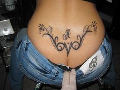 a woman's stomach with the word love tattooed on it