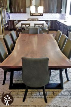 a large wooden dining table surrounded by chairs