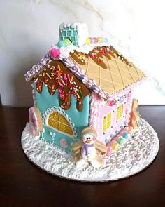 a gingerbread house with sprinkles and icing