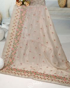 Embrace the ethereal charm of our Oatmeal-White floral embroidered organza saree, paired with an exquisitely crafted printed blouse. The sheer, airy fabric adorned with delicate floral embroidery captures a timeless elegance and modern sophistication. Perfect for any special occasion, this ensemble ensures you radiate grace and beauty. Step into a world of refined allure and leave a lasting impression. The blouse comes with an added allowance, and it can be altered to a standard size of 34"-42" Organza Saree With Floral Embroidery For Reception, Reception Organza Saree With Floral Embroidery, Organza Traditional Wear With Floral Embroidery For Receptions, Off White Tissue Silk Traditional Wear With Dupatta, Floral Embroidered Organza Traditional Wear For Reception, Floral Embroidery Organza Traditional Wear For Reception, Sheer Dupatta Art Silk Embroidered Fabric For Reception, Sheer Dupatta Embroidered Art Silk Fabric For Reception, Reception Embroidered Sheer Dupatta In Art Silk