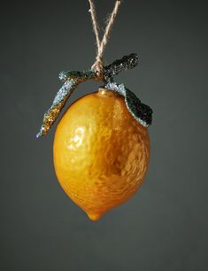 an orange ornament hanging from a string