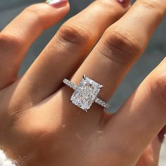 a woman's hand with a diamond ring on it