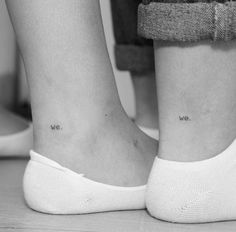 two people with small tattoos on their legs, one has the words we are in cursive writing