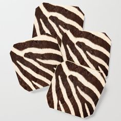 four zebra print coasters sitting on top of each other