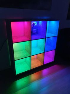 a multicolored display in the corner of a room with light coming from it