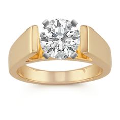 a yellow gold ring with a round diamond