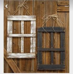 an old window is hung on the side of a wooden wall with twine strings attached to it