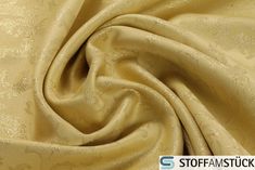 a close up shot of a gold colored fabric