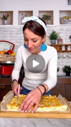 a woman is making some food on a tray with a knife and fork in it