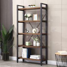 a book shelf with books and plants on it in the corner of a living room