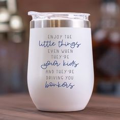 a white wine glass with blue writing on it