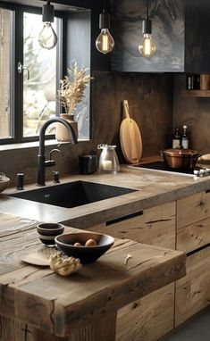 a kitchen with an island made out of wood and lights hanging from it's ceiling