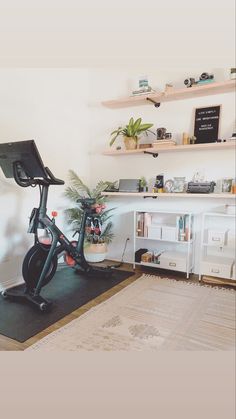 an exercise bike in the corner of a room with shelving on the wall behind it