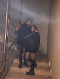 two people standing on stairs in the fog