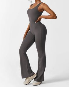 Buttery smooth compression fabric Removable cup pads High elasticity and moisture wicking fabric V-waist hip pleat design Squat proof Fabric: 78% Nylon + 22% Spandex Indulge in stylish comfort everytime you wear this jumpsuit crafted from resilient, shape-retaining fabric boasting a moisture-absorbing texture. Engineered with a flexible four-way stretch, it ensures supreme comfort while maintaining a dry feel. A chic cutout adorns the back, elegantly accentuating all your curves. Embrace a flattering silhouette with its deep V neckline and hip-enhancing scrunch detail. The flared leg design not only elongates but also beautifully contours your legs. Versatile and stylish, this jumpsuit effortlessly transitions from casual outings to rigorous workouts, making it a wardrobe essential for eve Sporty High-stretch Jumpsuits With Seamless Construction, Seamless High-stretch V-neck Activewear, Backless High-stretch Workout Jumpsuits And Rompers, Sporty Jumpsuits With Built-in Bra And High Stretch, Moisture-wicking Solid Color Gym Jumpsuit, Flare Jumpsuit, Compression Fabric, Squat Proof, Moisture Wicking Fabric