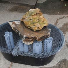 a rock sitting on top of a metal grill