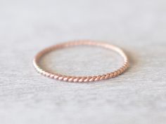 D E S C R I P T I O N Super thin rose gold filled twist ring. Can be worn on its own or with other rings. Rings are made to order, and available in quarter and half sizes. Small sizes are great as pinky or knuckle rings. M A T E R I A L S 14k Rose Gold Filled  S I Z E Band thickness: 1mm W H A T - I S - G O L D - F I L L E D ? Gold filled is a layer of gold bonded onto brass or another type of metal. Gold filled jewelry is 50 to 100,000 times thicker than gold plating. If cared for, gold filled jewelry can maintain its quality for a lifetime. N O T E S Rings are soldered and left untouched, which makes it barely noticeable but you may see imperfections at the joints. Please check current processing times and estimated shipping in 'Shipping and Policies'.  If you require items at a faster t Simple Rings For Women, Gold Twist Ring, Dainty Rose, Simple Rings, Gold Bond, Etsy Gold Ring, 14k Rose Gold Ring, Knuckle Rings, Twist Ring