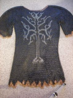 a knitted t - shirt with a tree on it