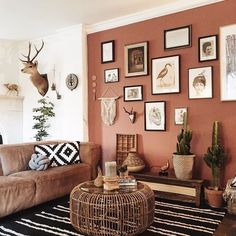 a living room filled with furniture and pictures on the wall