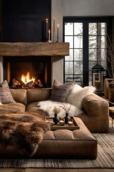 a living room filled with furniture and a fire place in the middle of the room