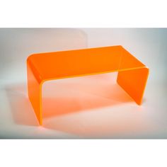 an orange table sitting on top of a white floor