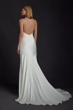 the back of a woman's white wedding dress, with an open - back